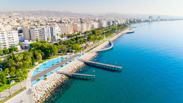 Aerial view of Molos, Limassol, Cyprus Aerial view of Molos Promenade park on the coast of Limassol city centre in Cyprus. Bird's eye view of the jetties, beachfront walk path, palm trees, Mediterranean sea, piers, rocks, urban skyline and port from above. republic of cyprus photos stock pictures, royalty-free photos & images