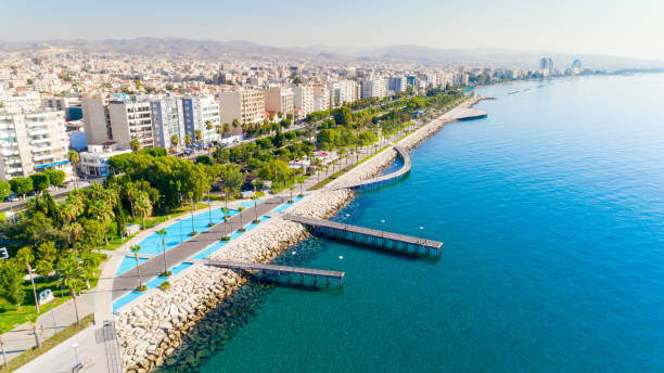 Aerial view of Molos, Limassol, Cyprus Aerial view of Molos Promenade park on the coast of Limassol city centre in Cyprus. Bird's eye view of the jetties, beachfront walk path, palm trees, Mediterranean sea, piers, rocks, urban skyline and port from above. limassol marina stock pictures, royalty-free photos & images