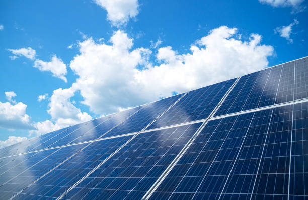 Blue solar panels over blue sky. Renewable energy. stock photo