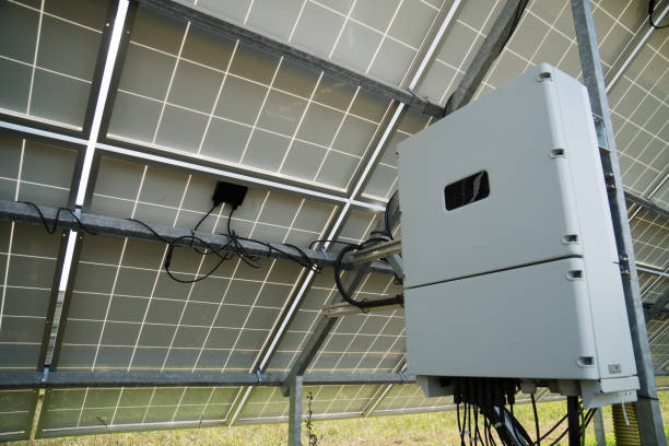 Inverter behind the solar panels. Renewable energy. stock photo