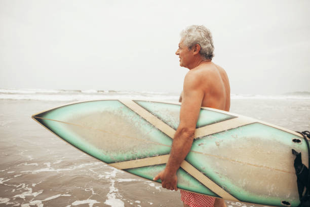 istock Senior man surfing 1041736300