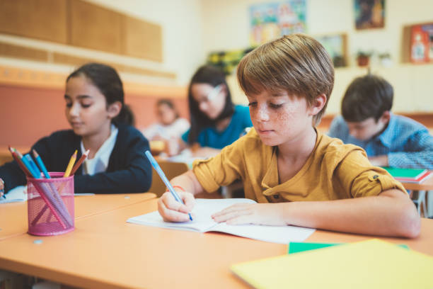 istock School children writing homeworks 1041738848