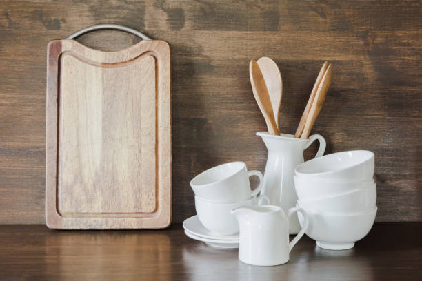 istock Crockery, white utensils and other different stuff on wooden tabletop. Kitchen still life as background for design. Copy space. 1041747420