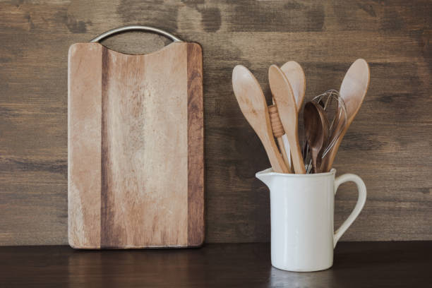 istock Crockery, white utensils and other different stuff on wooden tabletop. Kitchen still life as background for design. Copy space. 1041747424
