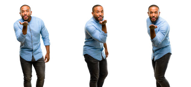 African american man with beard expressing love, blows kiss at camera, flirting African american man with beard expressing love, blows kiss at camera, flirting young man wink stock pictures, royalty-free photos & images