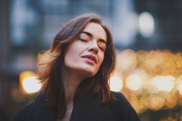 istock Charming young woman smiling with eyes closed. 1041756396