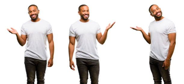 African american man with beard holding something in empty hand