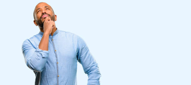 istock African american man with beard thinking and looking up expressing doubt and wonder 1041757640