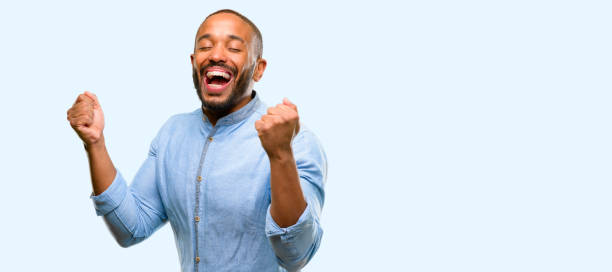 istock African american man with beard happy and surprised cheering expressing wow gesture 1041757710