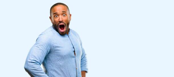 istock African american man with beard happy and surprised cheering expressing wow gesture 1041757806