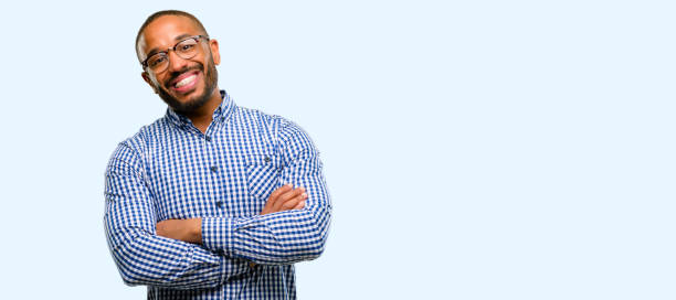 African american man with beard with crossed arms confident and happy with a big natural smile laughing African american man with beard with crossed arms confident and happy with a big natural smile laughing isolated over blue background braces stock pictures, royalty-free photos & images