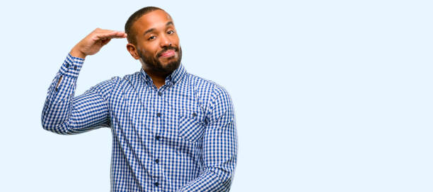 istock African american man with beard holding something, size concept 1041758606
