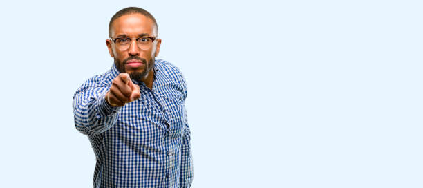 istock African american man with beard pointing to the front with finger 1041758616