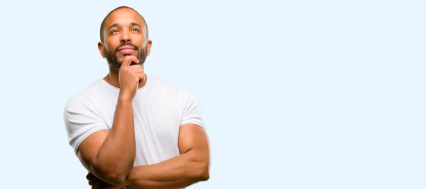 istock African american man with beard thinking and looking up expressing doubt and wonder 1041758834