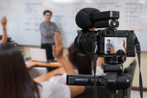 Professional digital Mirrorless camera with microphone on the tripod recording video blog of Asian teacher in the classroom,Camera for photographer or Video and Technology Live Streaming concept stock photo