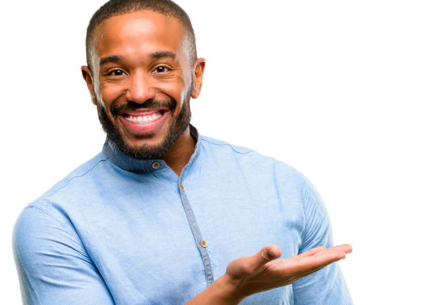 istock African american man with beard holding something in empty hand 1041762412