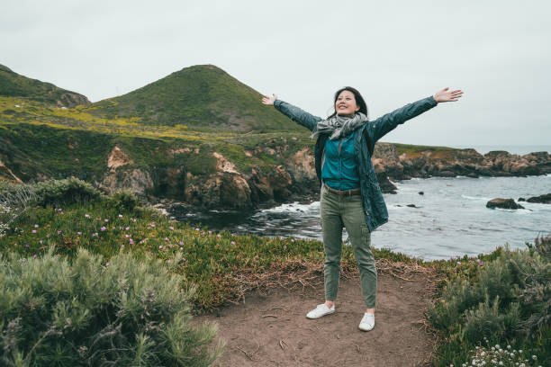 istock woman opening her arms standing on coast 1041762822