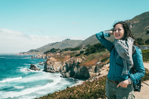 istock woman standing on coast with pleasant mood 1041763140