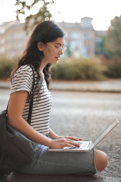 istock Girl sitting with laptop 1041767560