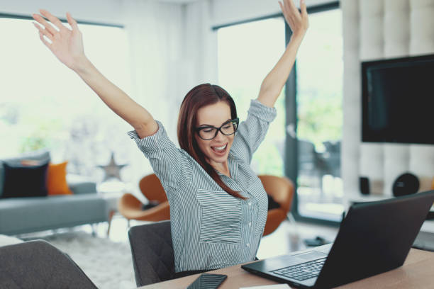 istock Happy modern woman win at laptop 1041777654