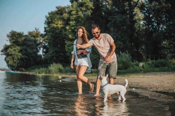 istock Young couple on the river with a dog 1041779150