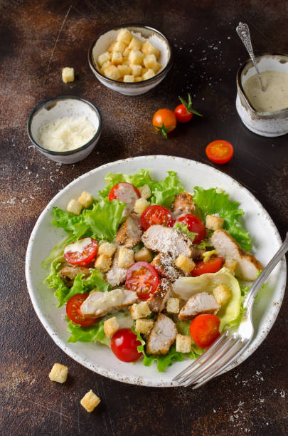 istock Caesar salad with chicken, tomatoes, Parmesan and croutons 1041782934