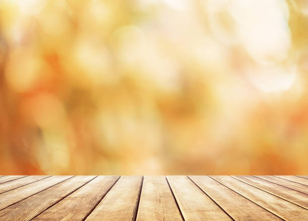 istock Wooden table top on blur abstract autumn background 1041790072