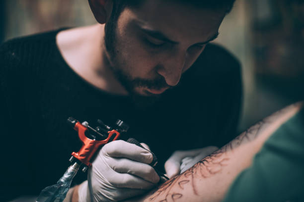 istock Artist tattooing 1041800680