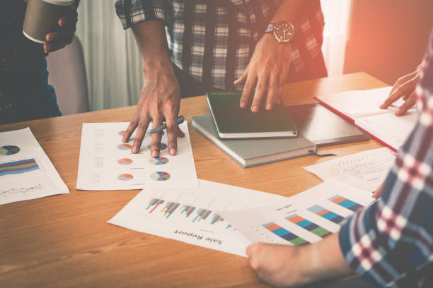 istock Hands pointing on data chart sheet for business meeting 1041801758