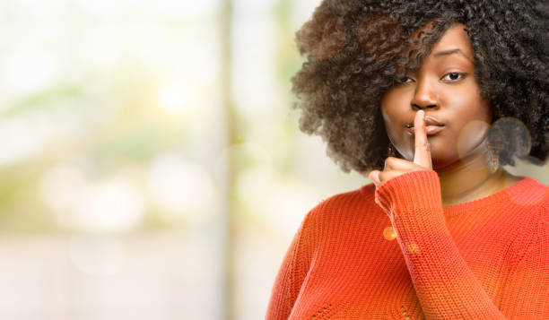 istock with index finger on lips, ask to be quiet. Silence and secret concept 1041802126