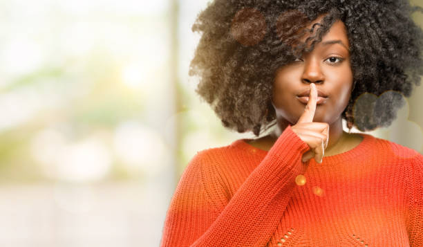 istock with index finger on lips, ask to be quiet. Silence and secret concept 1041802130