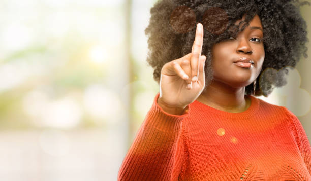 istock raising his finger, the number one 1041803612
