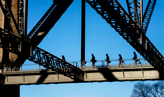 Sydney, Australia - August 16, 2018: Some of the brave folk who climb up and explore the famous Sydney Harbour Bridge in Sydney, Australia.