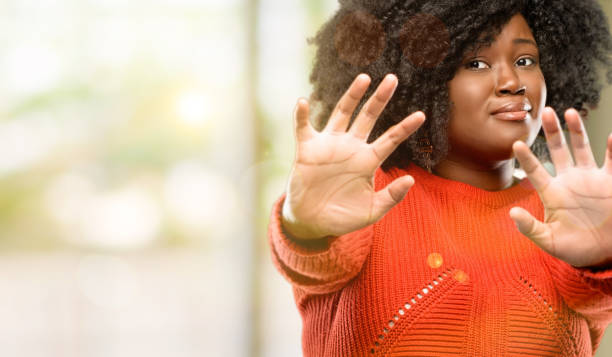 istock disgusted and angry, keeping hands in stop gesture, as a defense, shouting 1041808990