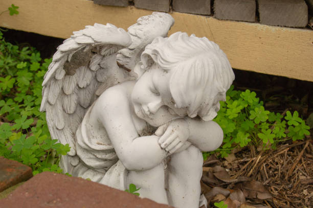 istock White statue of an sleeping angel 1041809156