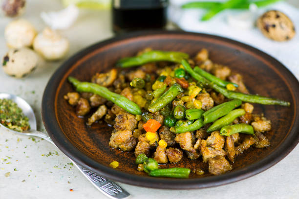 istock fried meat with vegetables and asparagus with spices 1041809314