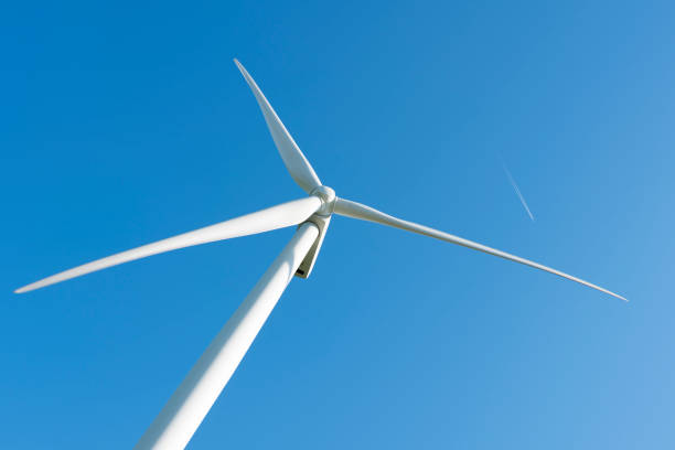 istock white wind turbine against blue sky 1041809340