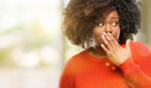 istock covers mouth in shock, looks shy, expressing silence and mistake concepts, scared 1041809922