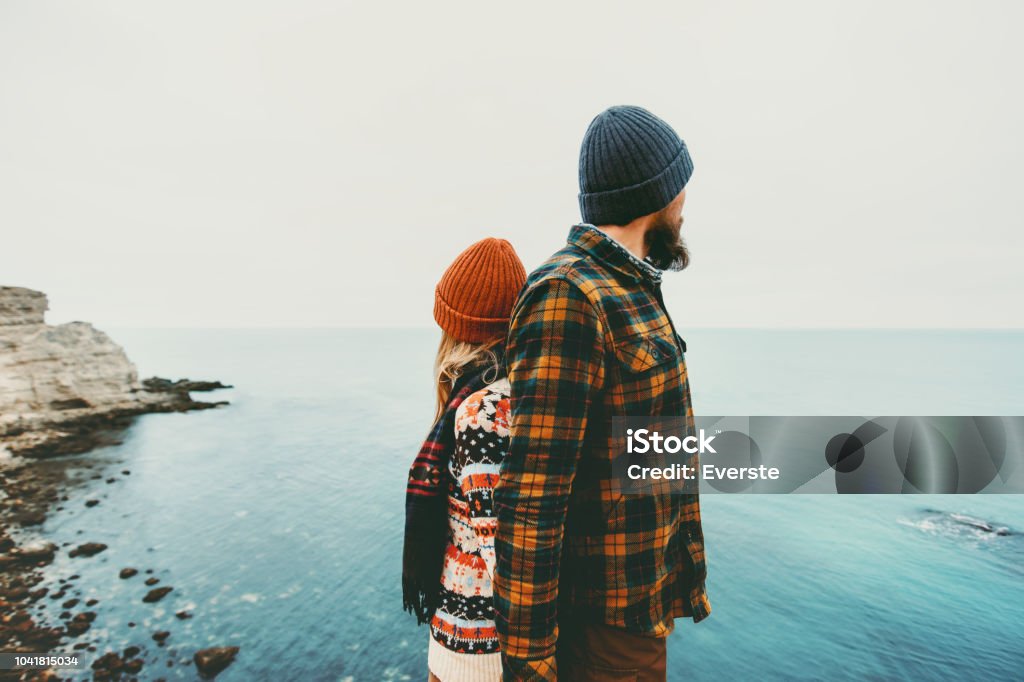 Couple lovers Man and Woman standing backs together Love and Travel happy emotions Lifestyle concept. Young family traveling romantic vacations autumn winter season Winter Stock Photo