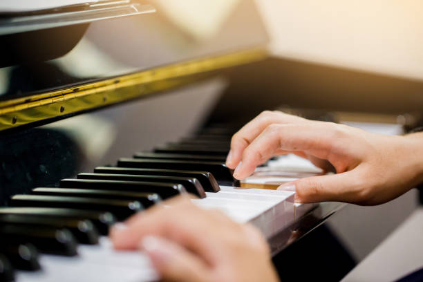 istock Boy play the piano with selective focus to piano key and hands. 1041817638