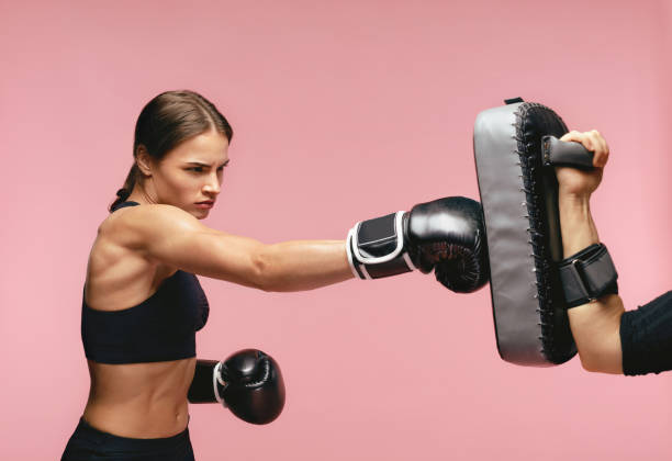 Sleet Unforeseen circumstances Temple Female Boxer In Gloves Training With Boxing Pads Stock Photo - Download  Image Now - Padding, Boxing - Sport, Punching - iStock
