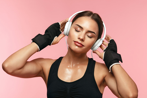 Sport Woman Listening Music In Headphones On Training, Enjoying Song In Earphones. High Resolution