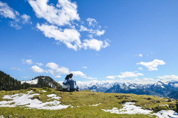 istock young couple sitting on mountain,  Schafberg mountain, Austria 1041821778