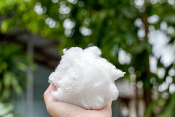 istock Hands holding polyester fiber with green blurred background.save environment concept 1041832384