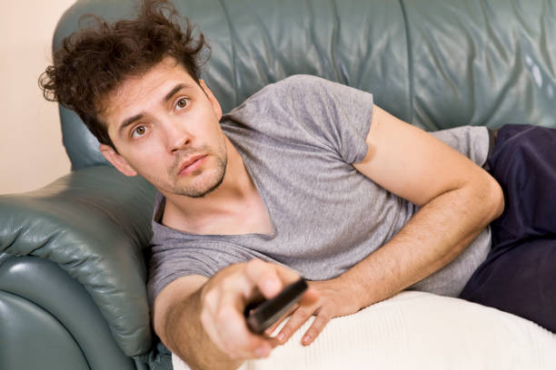 istock Man relax after work and watching tv 1041835882