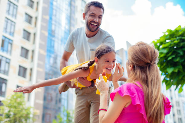 Family Using Sunscreen 900+ Friends And Family Day Stock Photos, Pictures & Royalty-Free ...