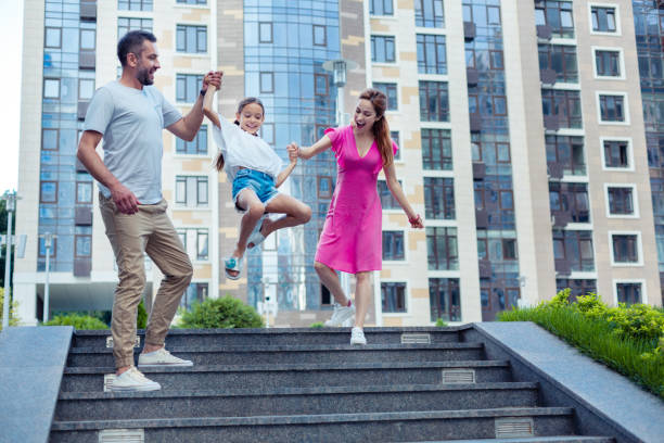 istock Happy positive parents holding their daughters hands 1041839640