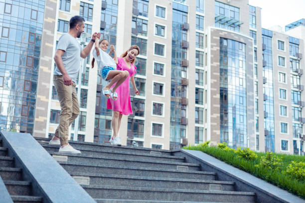 istock Delighted nice girl jumping on the stairs 1041839646