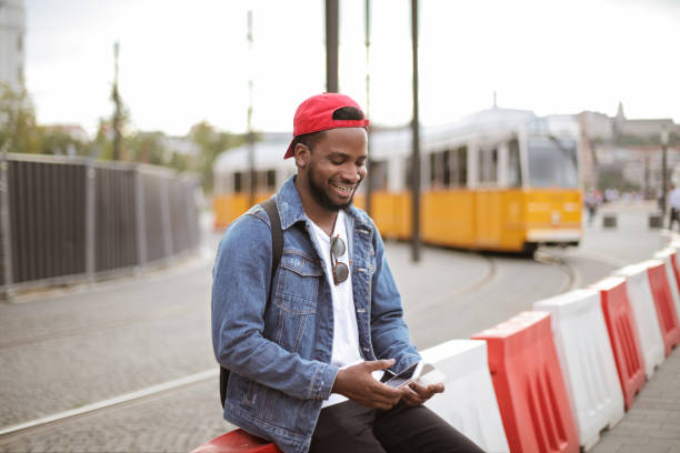 istock Handsome black guy with smartphone in street 1041847244