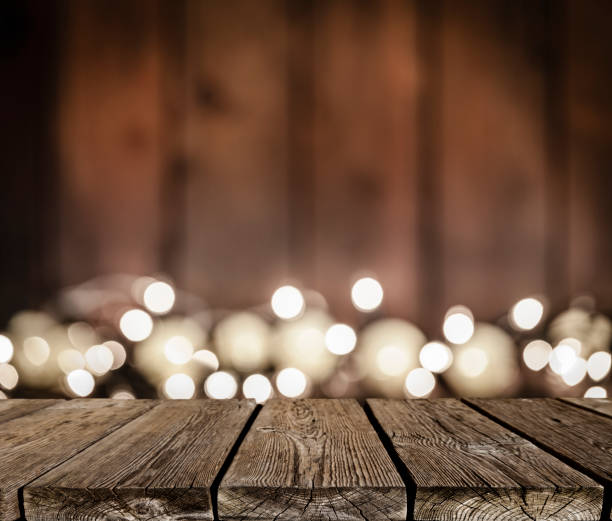 istock Empty rustic wooden table with blurred Christmas lights at background 1041850230